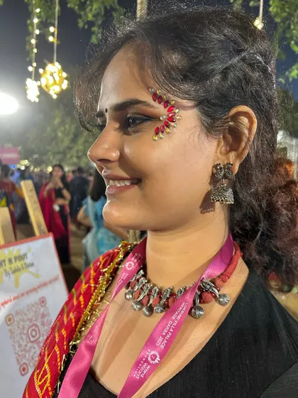 A beautiful red and gold jewel design that perfectly complements this client's traditional attire.