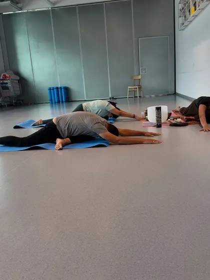 A deep stretch in a wide-legged forward fold during a session at IKEA. This pose is excellent for releasing tension in the hamstrings and lower back.