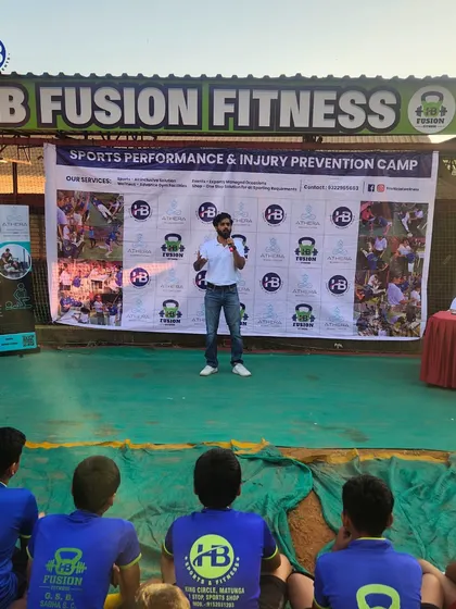 A speaker addresses our young athletes at the HB Fusion Fitness Sports Performance & Injury Prevention Camp, providing them with valuable knowledge to enhance their game.