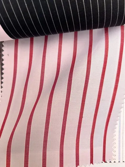 A reversible fabric with bold red and white stripes on one side and black and white on the other, offering unique possibilities for custom design.