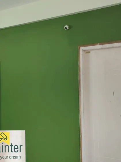 Another view of the solid green accent wall, showing the clean lines next to the white door frame.