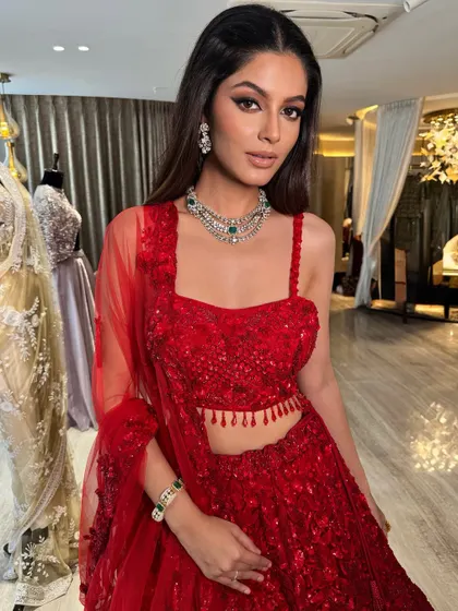 Another shot from the Odelia brand shoot. The sharp winged eyeliner adds a touch of modern drama to this traditional red lehenga, making it perfect for a contemporary bride.