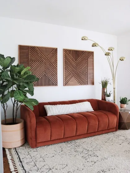 Our set of two 'Brixon' square wood art panels hung above a couch. The matching geometric patterns create a balanced and sophisticated look in this living room.