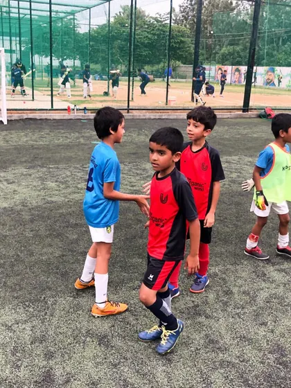 A moment of sportsmanship between players after a play, reflecting the positive values we instill in our academy.
