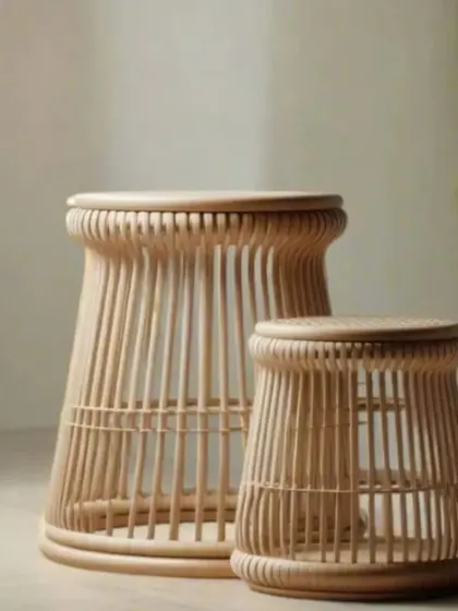 A pair of our nested rattan side tables or stools. The slatted design is both modern and timeless, and their varying sizes allow for versatile use as seating, tables, or plant stands.