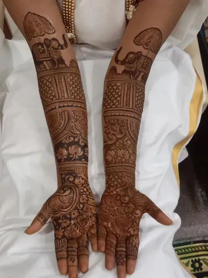 For this South Indian bride, we incorporated traditional elephant motifs with umbrellas, a symbol of royalty and celebration, into her full bridal design.