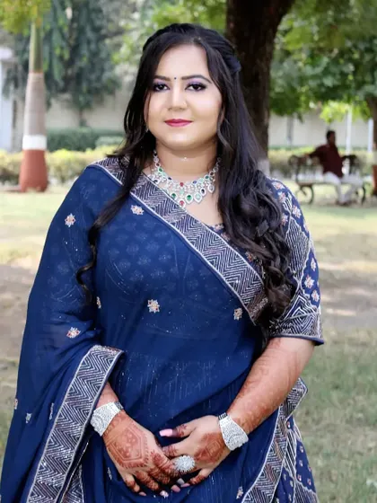 A full view of the engagement bride in her beautiful blue bandhani-style lehenga.