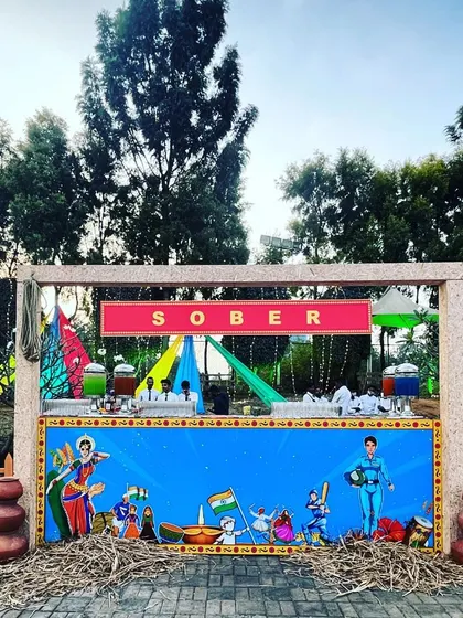 A fun and colorful bar we created for a corporate event. The counter features vibrant, traditional Indian artwork under a sign that playfully reads "SOBER," adding a unique and humorous touch.