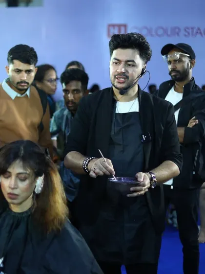 On stage at PBI Mumbai, I'm explaining my color placement strategy to an engaged audience of hair professionals.