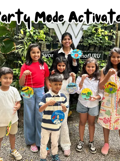 Party mode activated. This happy group is ready to celebrate, holding up the colorful art they made together. My parties are designed to be fun, engaging, and full of creative energy.