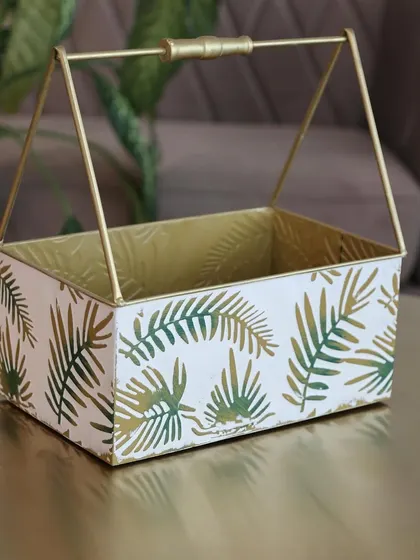 A single metal basket with our signature green leaf print. Its compact size and elegant handle make it a versatile piece for any room in the house.