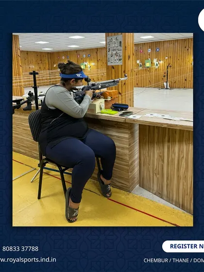 A female shooter takes aim from a seated position at our range. We provide a supportive environment for everyone to pursue their goals, whether for recreation or competitive sport.
