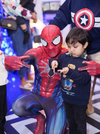 Spider-Man makes a special appearance, showing the birthday boy how to do his signature web-slinger pose.