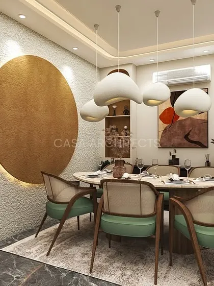 A dining room render with soft green chairs, a round marble table, and a large, textured gold wall art piece that serves as a stunning focal point.