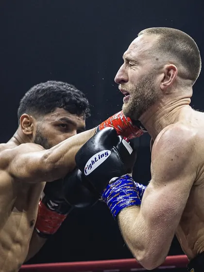 A powerful shot of a fighter connecting with a punch, showcasing his skill and power.