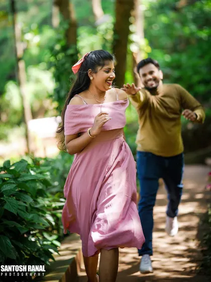 A moment of pure joy and laughter captured during a playful chase in a beautiful garden.