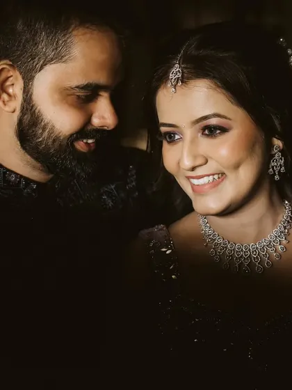 A sweet, candid moment where the groom looks lovingly at his bride. Her bright, happy smile is the centerpiece of this intimate and joyful portrait.