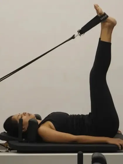 Another variation with feet in straps, this time with legs extended to the ceiling to work the lower abs and hamstrings.