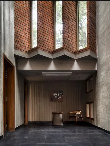 The entrance foyer of the Brick House, where a composition of varied materials and textures welcomes visitors into a space of architectural poetry.