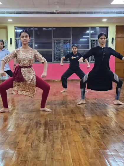 Students holding a strong, grounded posture during a Mayurbhanj Chhau class, building their foundational strength.