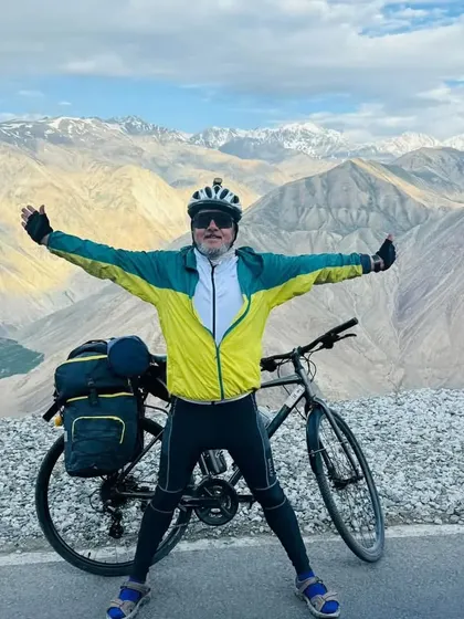 Bharat Thakur Sir, a new Super Randonneur, posing victoriously in the mountains. This photo was from a previous tour, showcasing his adventurous spirit.