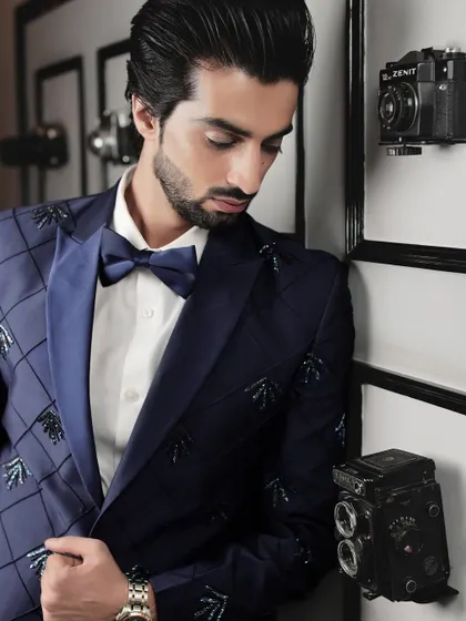 Detail is everything. This shot highlights the craftsmanship of the beadwork and the sharp cut of the lapel on our navy blue statement tuxedo.