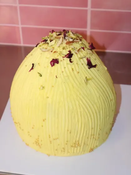 Our creative take on a traditional sweet for Ganesh Chaturthi. This is our Modak cake, shaped like the classic dumpling and decorated with pistachios, almonds, and rose petals.