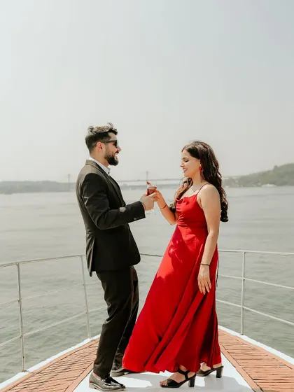 A playful dance on the deck of a boat, capturing the joy and celebration of their love story in Goa.