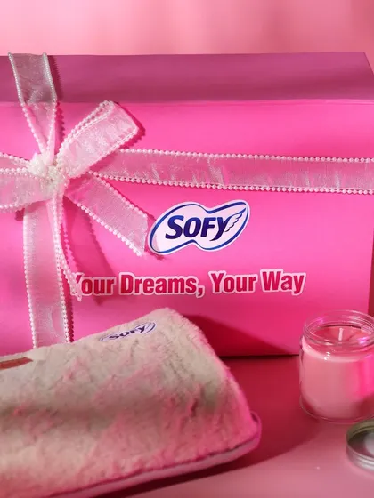 A still shot of the Sofy hamper, showing the gift box alongside some of the curated items like the candle and cozy pouch.