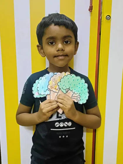 Another happy student with his fan of seasonal trees. This project combines learning with a fun craft that they can take home.