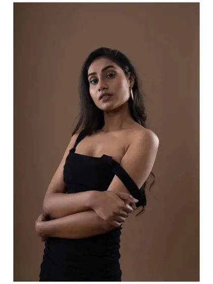 A moody and expressive portrait from the same session. The off-the-shoulder strap adds a touch of vulnerability and style, showcasing the model's acting range.