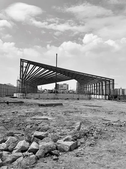 "Roof Likes To Swing": A series of black and white photos tracking the progress of a large-scale steel roof structure for an experience center in Chennai.