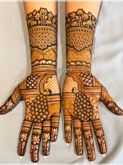 A symmetrical bridal design featuring majestic peacocks on the palms. The arms are decorated with bands of floral and geometric patterns, creating a full and balanced look.