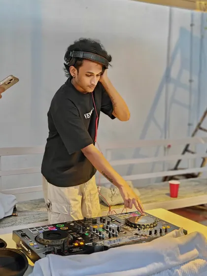 Tuning into the frequency of an afternoon party. Headphones on, world off, ready to mix the perfect set for a relaxed yet energetic open-air event.