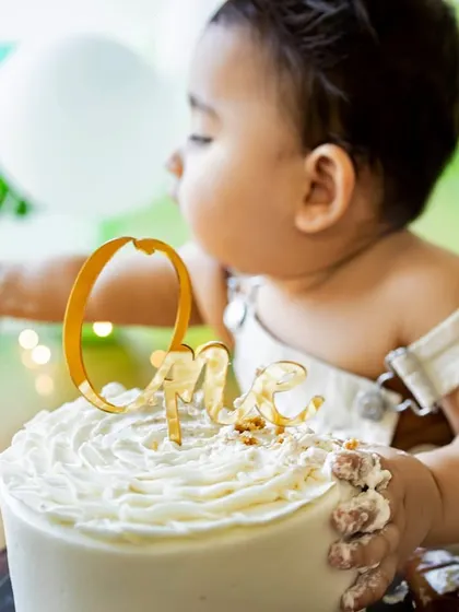Getting his hands right into the frosting. I love capturing the texture and mess of a cake smash, from the first touch to the final flip of the cake.