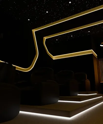 The view from the entrance, showcasing the dramatic step lighting and the inviting glow of the custom bar. It’s a space that makes an impression the moment you walk in.