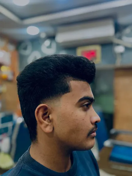 A classic taper fade that is clean and timeless. This haircut gradually gets shorter down the sides and back for a subtle, polished finish.