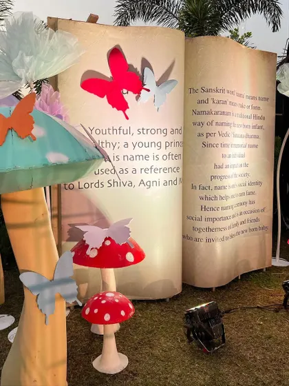 A fairytale photo booth with a giant open book, mushroom props, and fluttering butterflies, perfect for a whimsical celebration.