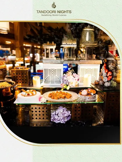 An elegant buffet station with curated dishes and decorative elements, showcasing how we integrate our food presentation seamlessly into the overall event design.