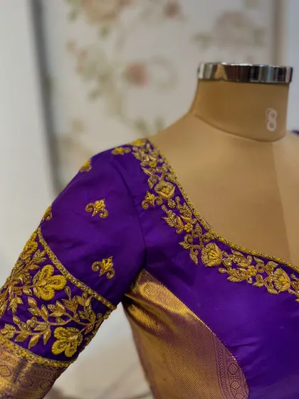 Another view of the purple blouse, showcasing the elegant neckline and perfect fit.
