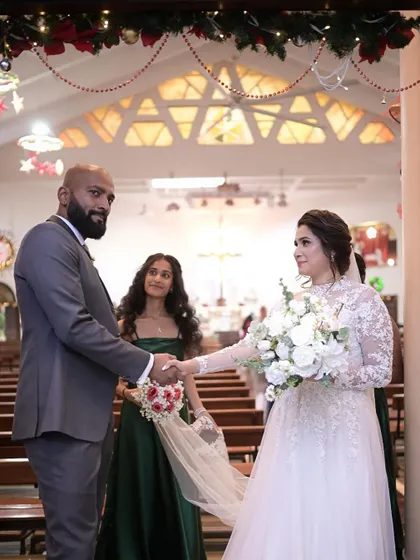 A beautiful moment during the wedding ceremony. The bride's classic makeup and hair look timeless and elegant.