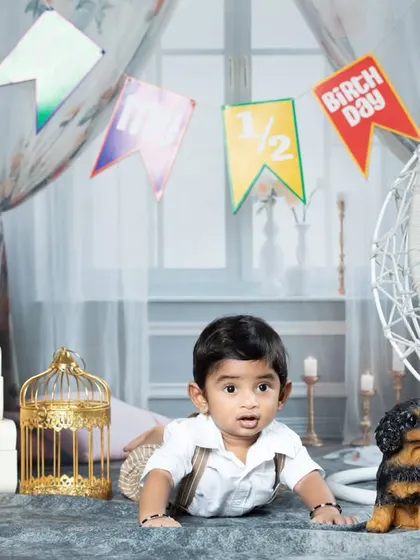 A playful moment from a half-birthday shoot, with the baby crawling towards the camera.