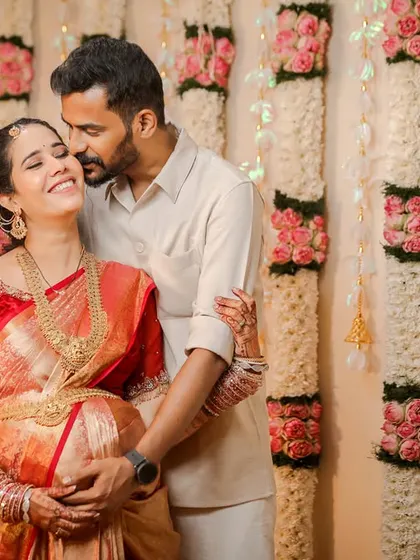 The joy and love between a couple are the heart of any baby shower. This candid shot captures a happy, loving embrace during a traditional Valaikaappu ceremony, showing the genuine connection we aim to photograph.