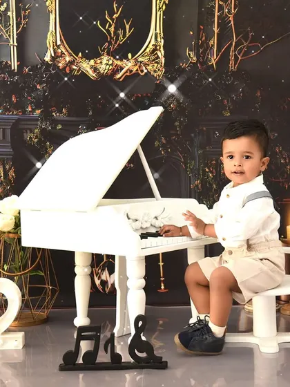 A handsome little pianist celebrating his second birthday. The classic piano setup is versatile and works beautifully for children of various ages.