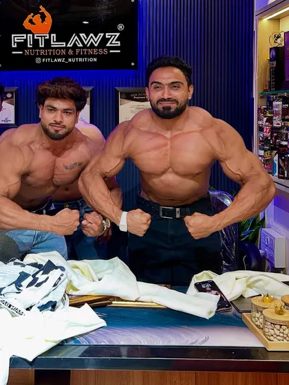 Posing with the team at the supplement store.