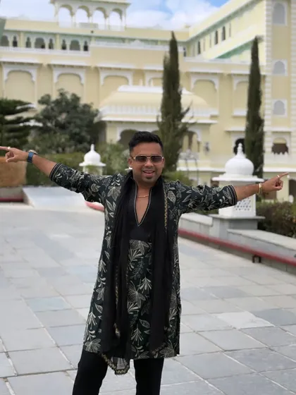 Pointing in both directions because the energy is coming from everywhere! Getting the crowd hyped for a helicopter Baaraat at a stunning destination wedding.
