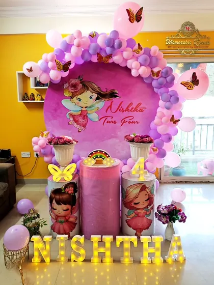 A full view of the enchanting fairy-themed setup, complete with marquee letters spelling out the birthday girl's name.