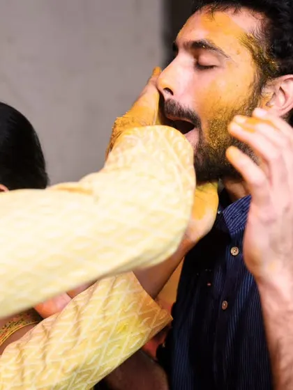 No one is safe during Haldi. A friend gets a mouthful of yellow paste in this hilarious, candid moment.