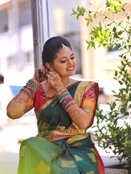 Another angle showcasing the bride's radiant look against a natural backdrop. The makeup is subtle enough to let her natural beauty shine through.