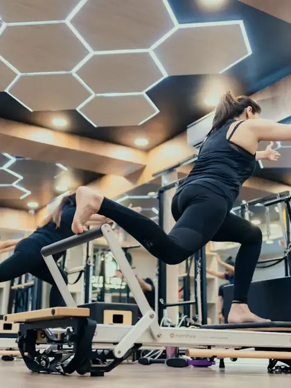 A dynamic lunge variation on the Reformer that challenges balance, strength, and flexibility simultaneously. The class moves together, creating a sense of shared accomplishment.